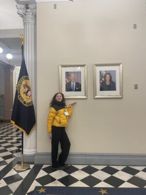 Woman in yellow jacket posing