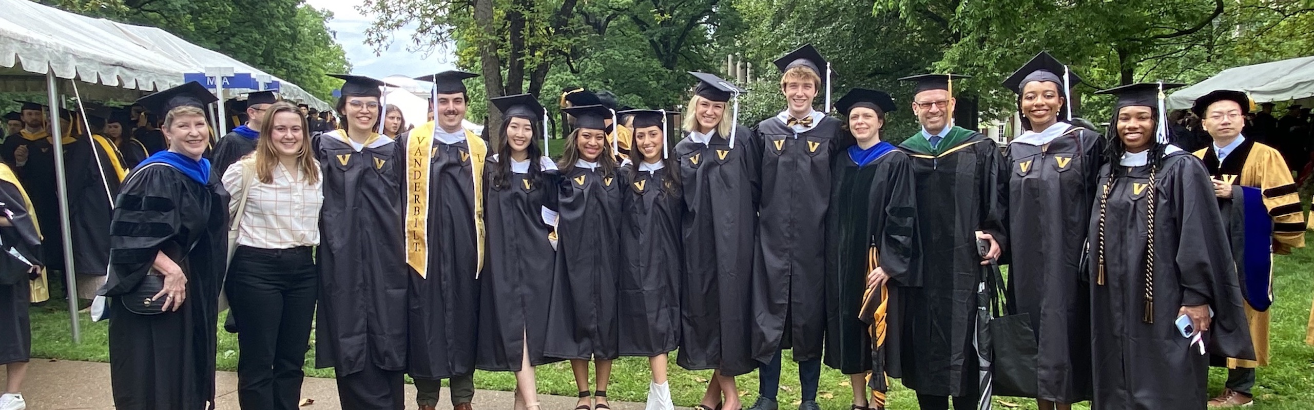 Graduates smiling at camera at commencement