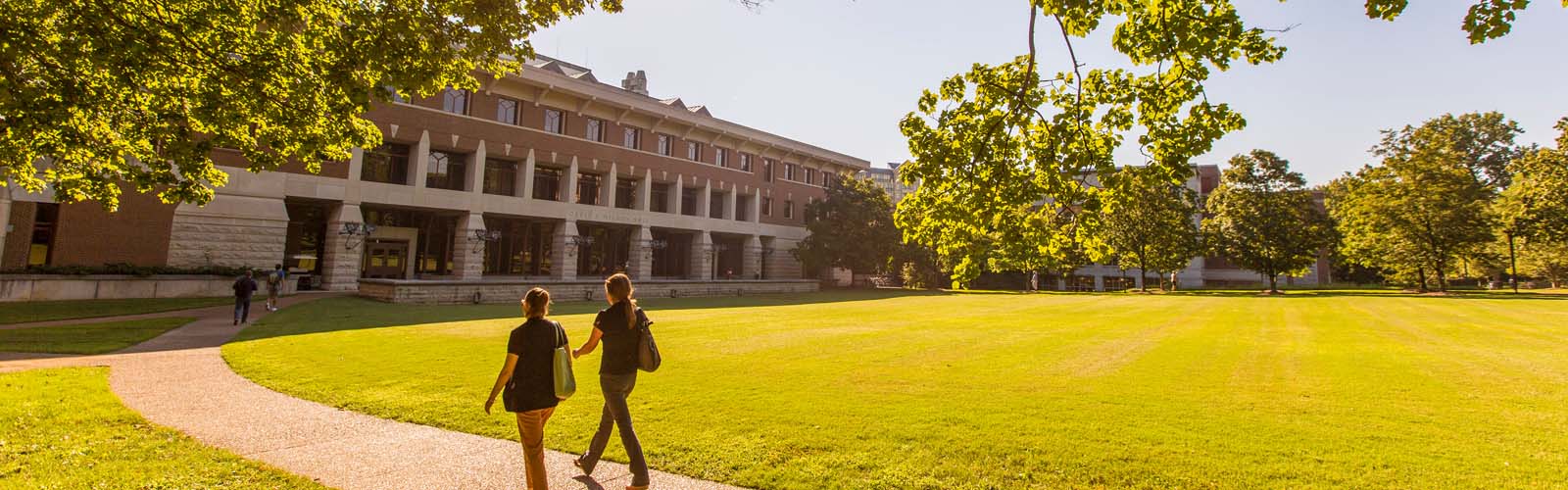 two people walking on campus