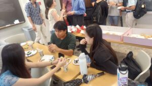 Math students gathered around classroom over tea and cookies