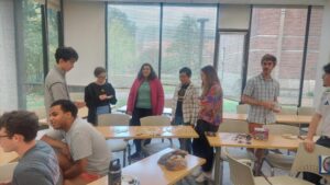 Math students gathered around classroom over tea and cookies