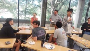 Math students gathered around classroom over tea and cookies