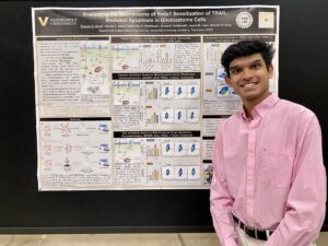 A photo of Shanay Desai presenting his research at a conference.