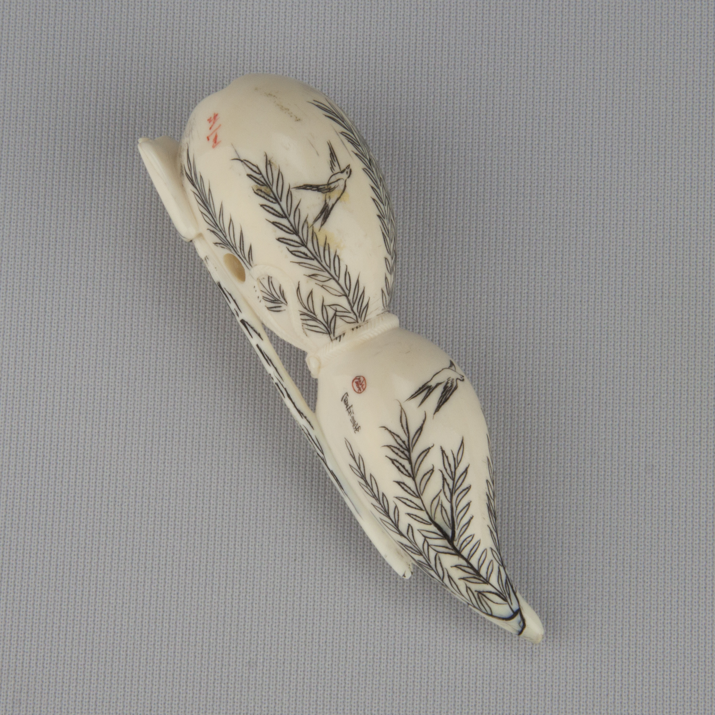 Netsuke depicting a double gourd with stained black designs of willows and birds, ca. 18th–19th century