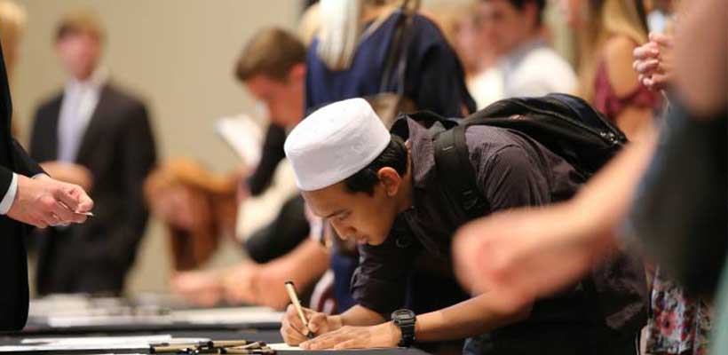 A photo of a student signing the Honor Code A photo of a student signing the Honor Code
