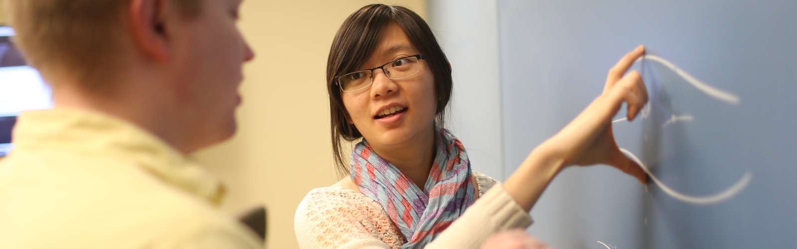 Two students at board.