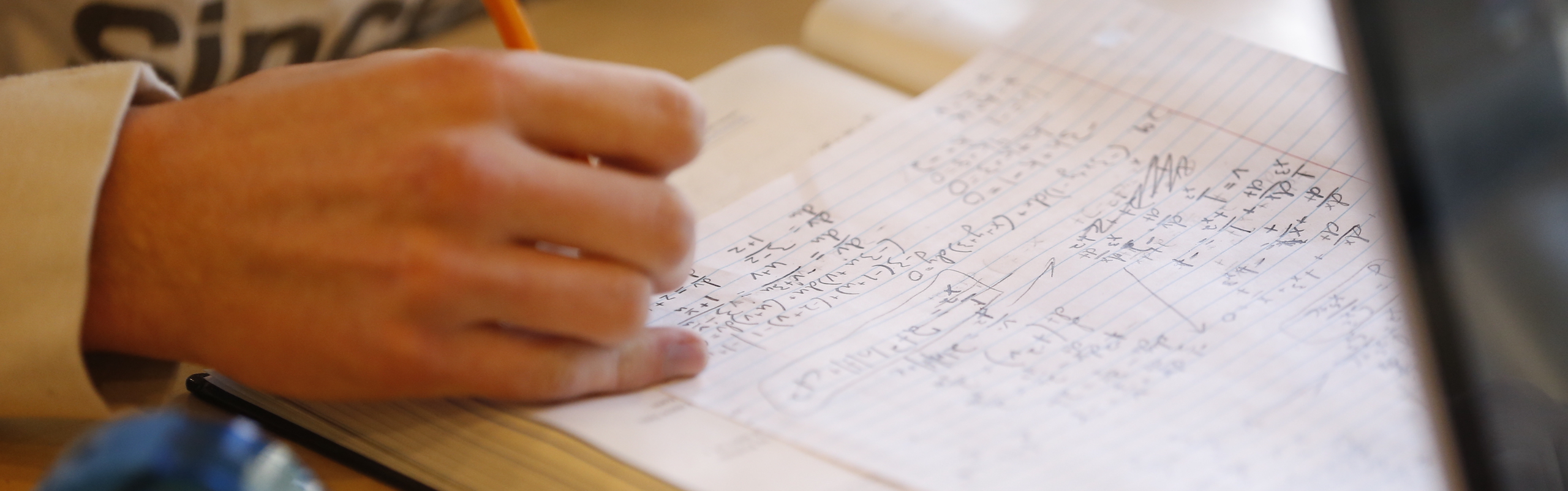 close up of student writing math problems