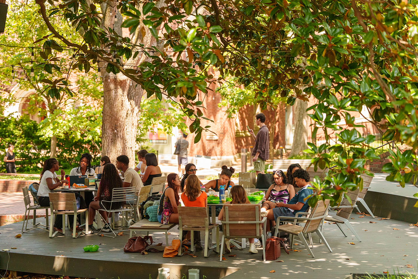 undergraduate students seated at tables on an outdoor patio at Vanderbilt