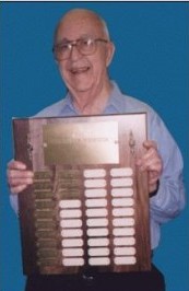 B.F. Bryant holding plaque of award winners