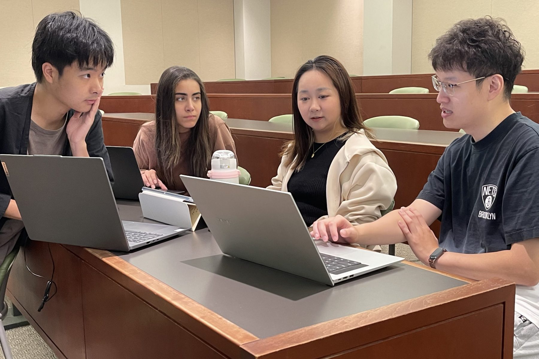 students shake hands at the end of a mock negotiation