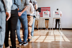 people standing in line to vote in an election