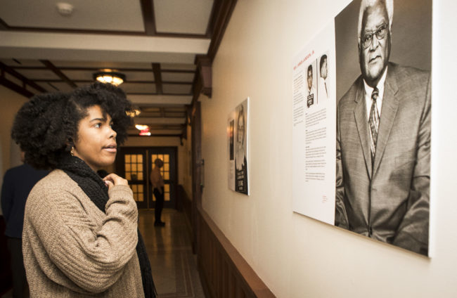 Olivia Cherry, a residential adviser for E. Bronson Ingram College, views a portrait of the Rev. James Lawson that is part of a Bronson gallery exhibition of portraits of Freedom Riders. (Susan Urmy/Vanderbilt)