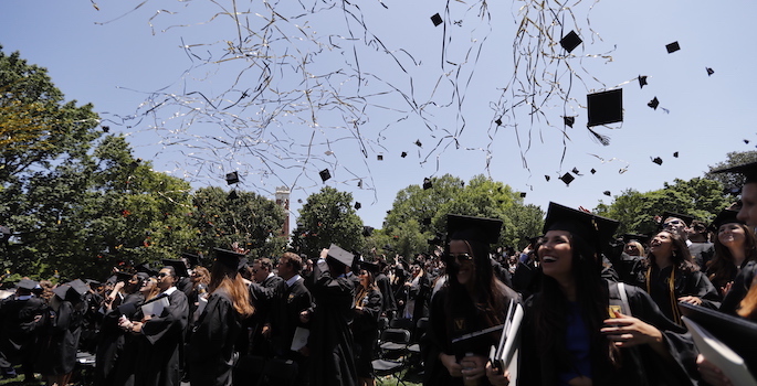 graduates tossing caps
