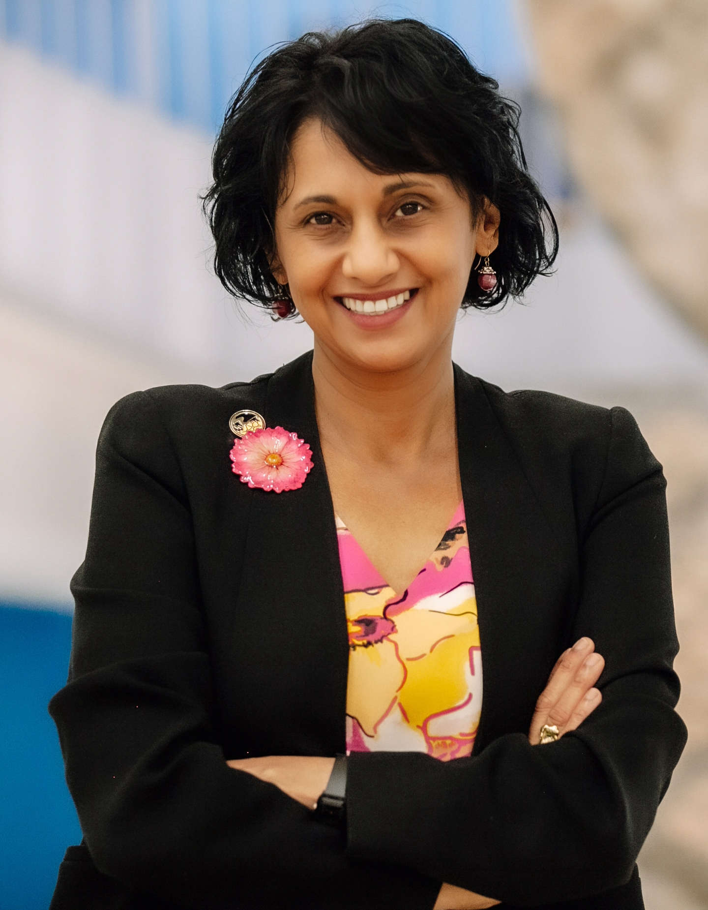 A woman standing with her arms folded across her chest.