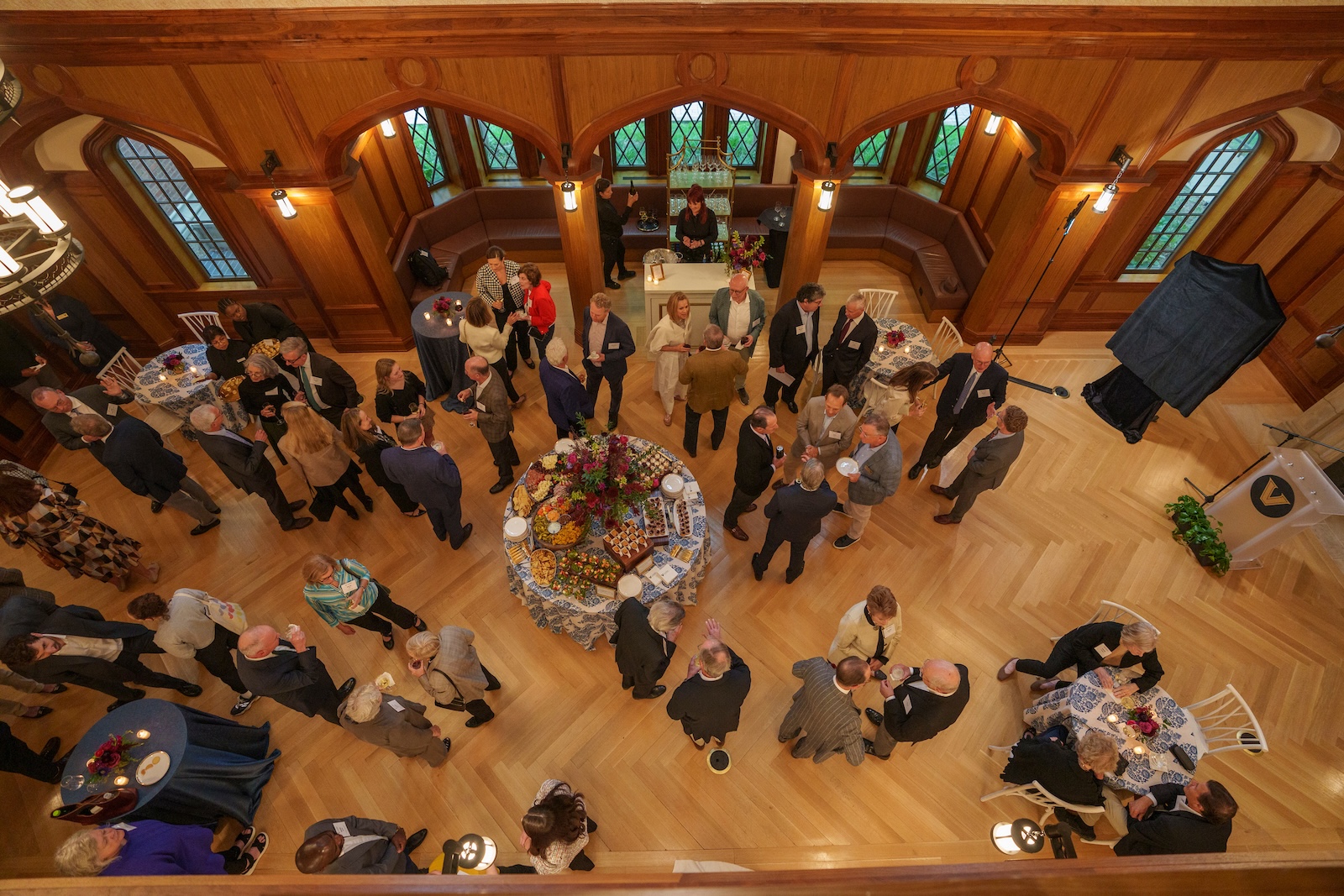 An overhead shot of a crowd of people in a gallery