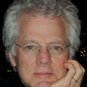 Man resting chin on hand smiling