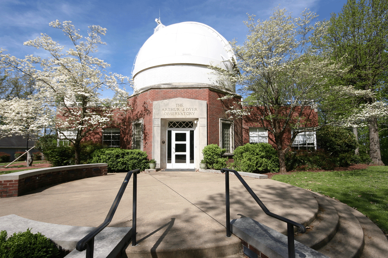 view of a formal table setting with floral centerpiece, other similar tables shown in background on the Dyer Observatory covered patio