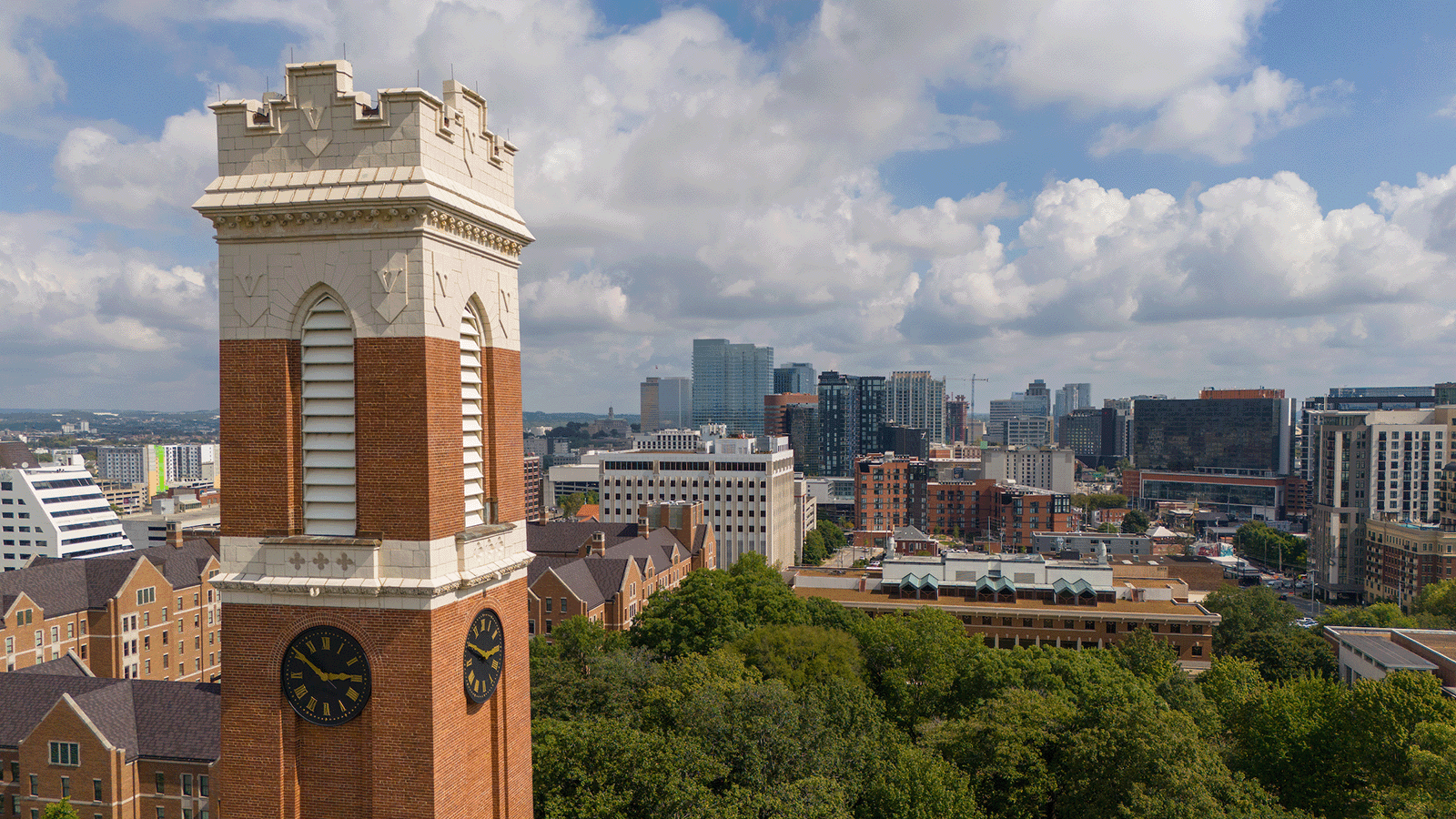 Aerial image of Vanderbilt University campus with Kirkland Hall bell tower in foreground and Nashville skyline in background