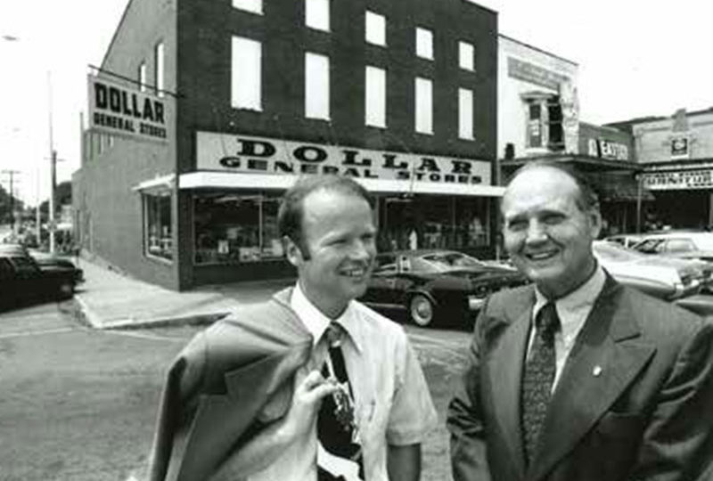 Cal Turner Jr., left, and Cal Turner Sr. chat outside a store in Scottsville, Kentucky, where their company began. Today, Dollar General is headquartered just outside Nashville, with stores in 44 states.