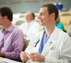 Pictured: MMHC candidate wears white coat in class