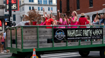 Pictured: people ride on a party wagon on Lower Broadway, photo by Andrew Nelles