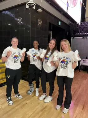 Athlete Ally volunteers get ready for a T-shirt toss at a Pride basketball game. (Submitted photo)