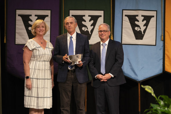 W. Kip Viscusi (center), University Distinguished Professor of Law, Economics and Management, was awarded the Earl Sutherland Prize for Achievement in Research by Interim Chancellor and Provost Susan R. Wente (left) and Faculty Senate Chair John McLean (right) during the 2019 Fall Faculty Assembly. (Joe Howell/Vanderbilt)