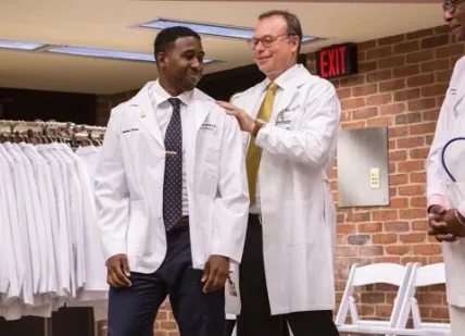 Matthew Nettles and Jeff Balser, dean of Vanderbilt University School of Medicine and president and CEO of Vanderbilt University Medical Center, at the White Coat Ceremony (Vanderbilt)