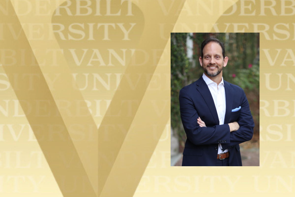 HEadshot of Alex Sevilla smiling with his arms crossed.