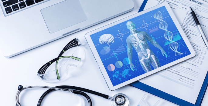 concept of precision medicine or personalized medicine depicting a tablet containing complex health data including x-rays, a laptop, stethoscope and eye shields