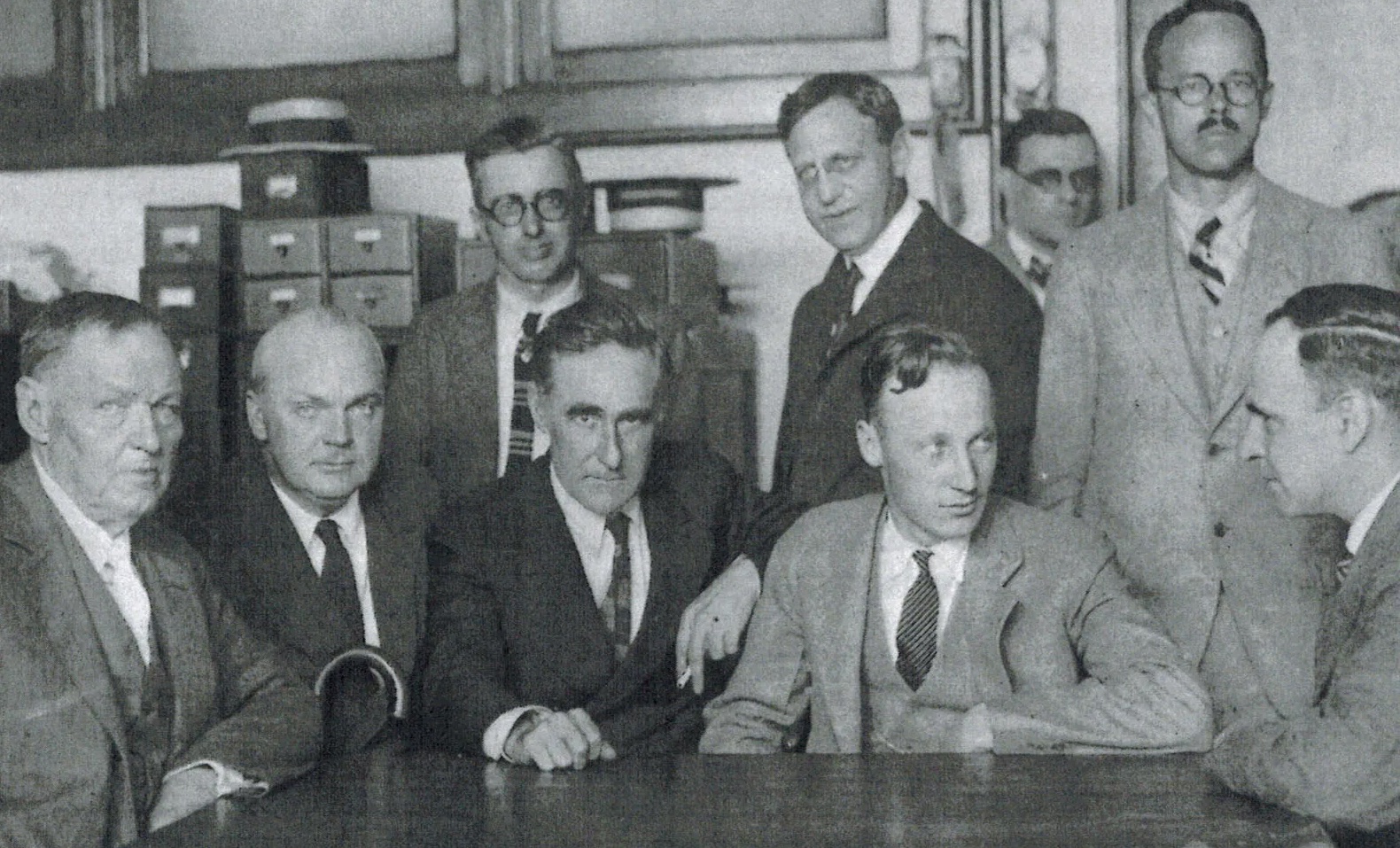 school teacher John T. Scopes, second from right, seated, along with his legal team, c. 1925. (Photo credit: AP)