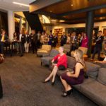 Owen Alumni Board Chair Emily Baker Tobin, BA’87, MBA’92 (standing), presides over the board-sponsored Owen Circle Reception Oct. 11 as alumni look on. Seated are Owen Alumni Council representative Kimberly Barboza, MS’95, EMBA’15 (right), and Bess Henderson, whose late husband and former Owen faculty member is the namesake of the Bruce D. Henderson Scholarship.