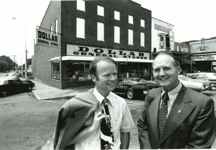 Cal Turner Jr., left, and Cal Turner Sr. chat outside a store in Scottsville, Kentucky, where their company began. Today, Dollar General is headquartered just outside Nashville, with stores in 44 states.