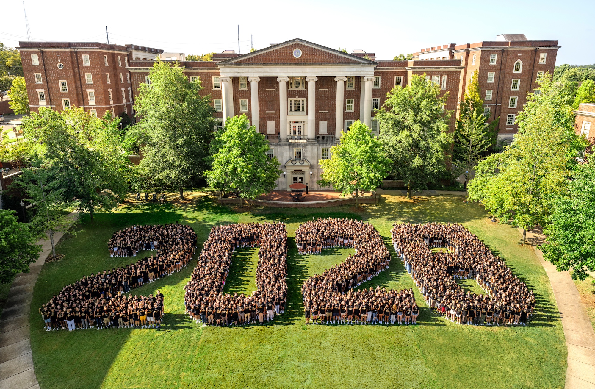 Class of 2028 students form a giant "2028" for their class photo.