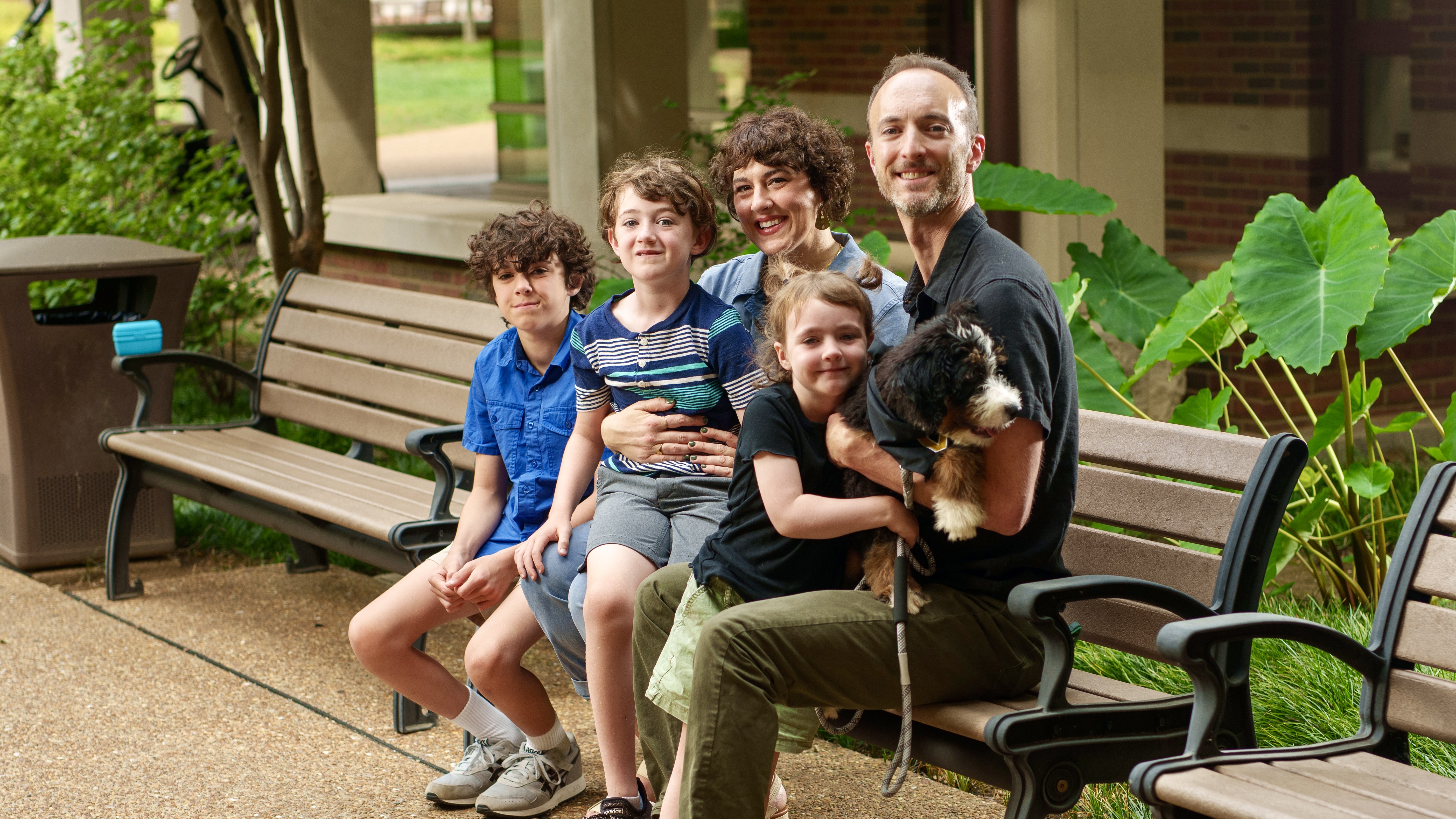 Robin Michael Jones, associate professor of hearing and speech sciences, with his wife, Kristin, their children Arlo, Bodhi and Leona, and their puppy, Pawley