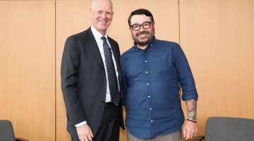 Pictured: Vanderbilt Business Dean Steenburgh (left) and Chef Sean Brock (right) stand together and smile at the camera.
