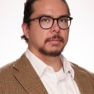 Gianni in glasses and a brown suit