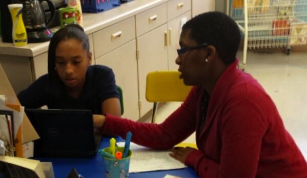 Teacher and student with laptop