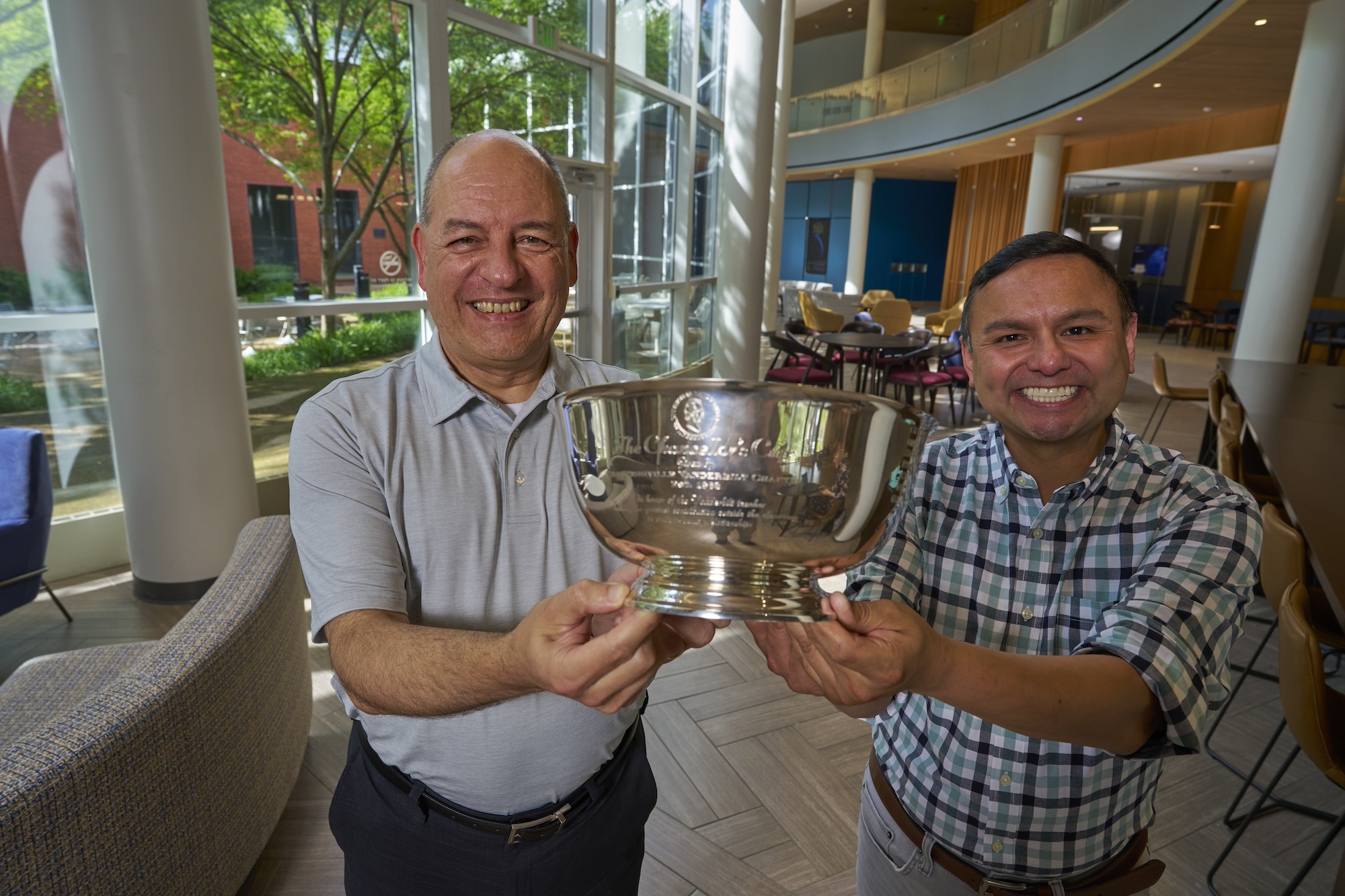 Gilbert Gonzales and Michael Lapré pose with the Chancellor's Cup.