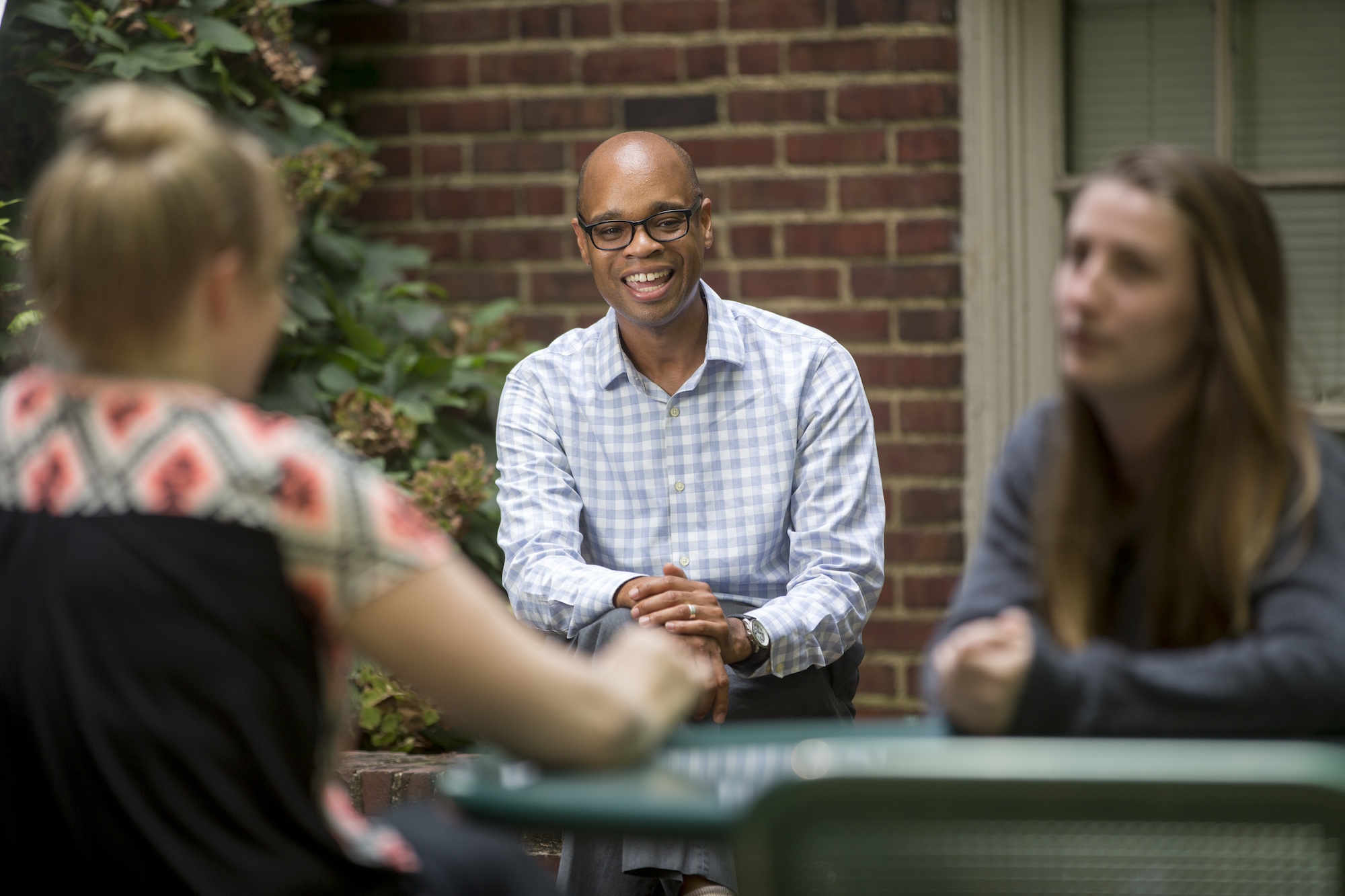 Duane Watson smiles while talking with students