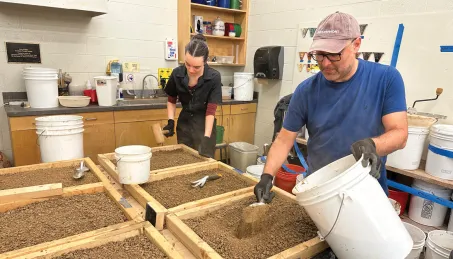 Reza Filsoofi and a student help process clay made from Vanderbilt soil. (Amir Aghareb)