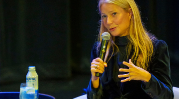 Pictured: Gwyneth Paltrow holds a microphone to speak alongside Vanderbilt faculty members Kelly Goldsmith and David A. Owens.