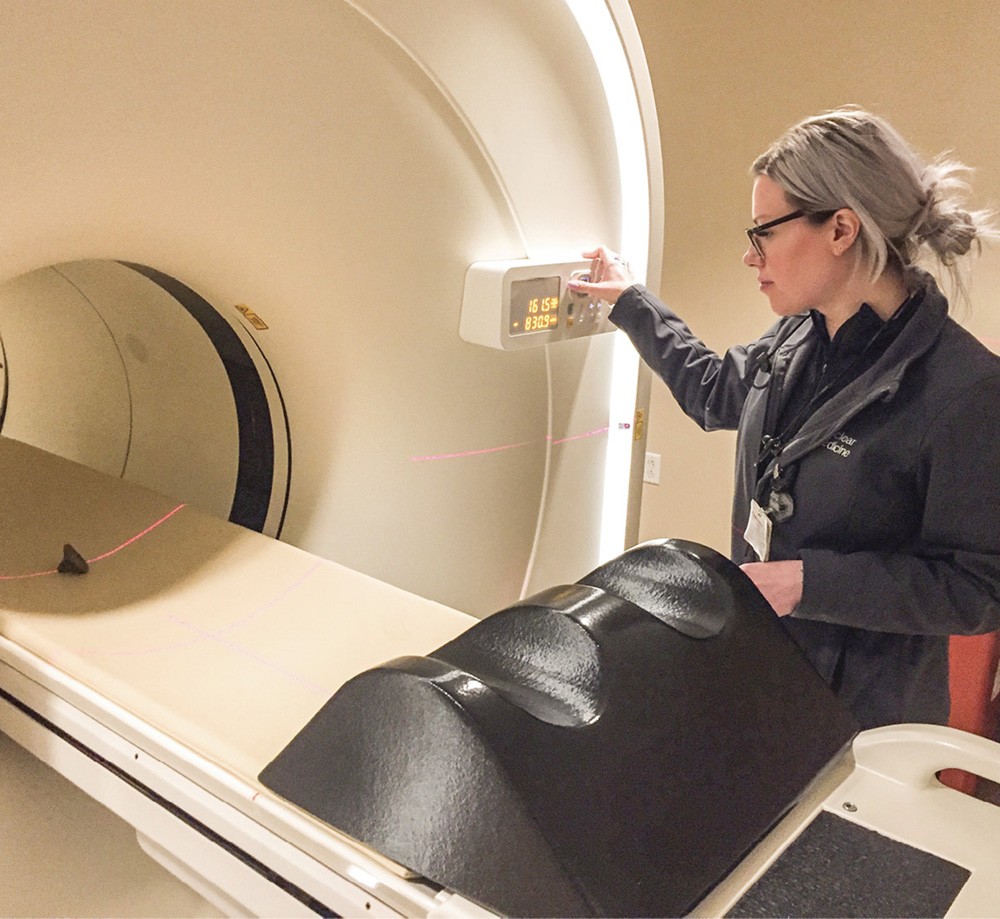 Anna Fisher, a certified nuclear medicine technologist, scans an ancient stamp using the PET/CT scanner. Photo courtesy Vanderbilt Fine Arts Gallery