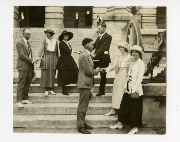 Photo taken outside the Tennessee State Capitol Building on Aug. 18, 1920. L-r: Rep. Banks Turner, BA 1910, shaking hands with Catherine Flanagan; Anita Pollitzer shaking hands with Rep. Harry Burn; Rep. Thomas Simpson (front) shaking hands with Betty Gram; Sue Shelton White at the very front.