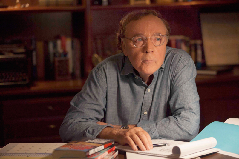 James Patterson sits at his desk. 