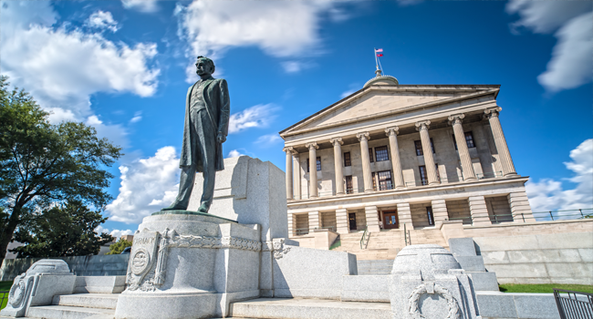 Tennessee State Capitol Building with a large statue of a man in the foreground.
