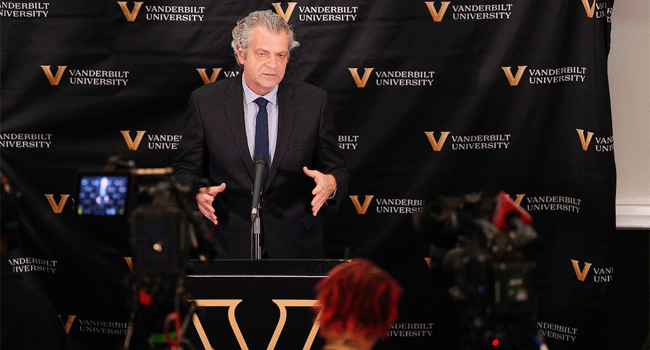 Chancellor Daniel Diermeier speaks at a podium in front of a backdrop covered with the Vanderbilt University V-logo and script announcing the university's partnership with the city in its bid for the Special Olympics