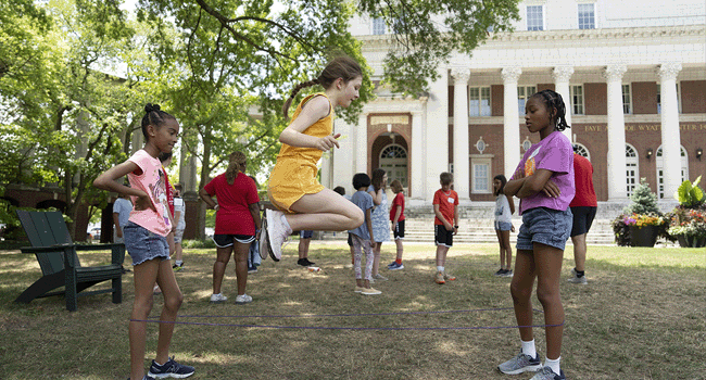 Schoolchildren play on the grass outside of the Wyatt Center on Vanderbilt's Peabody Lawn