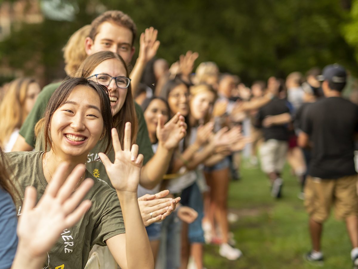 Students cheer and throw the VU hand sign on campus