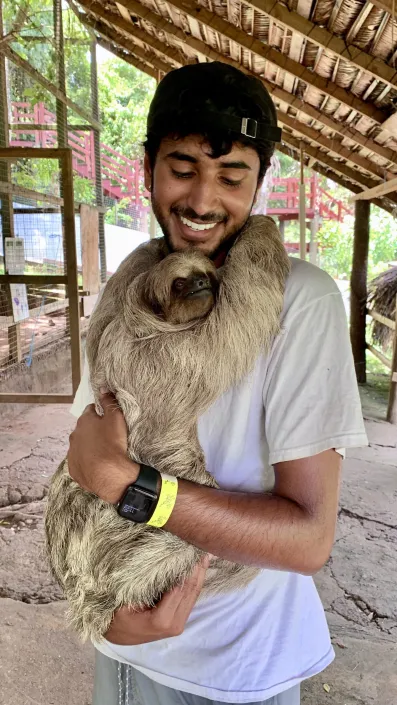 Vivek Kumar snuggles a sloth while on a medical volunteer trip in Honduras. (Submitted photo)